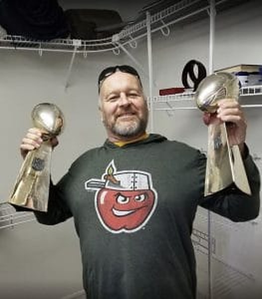 Chuck Lubbert holding two moving awards